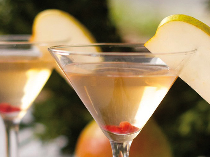 Pear martini in martini glass with slice of pear