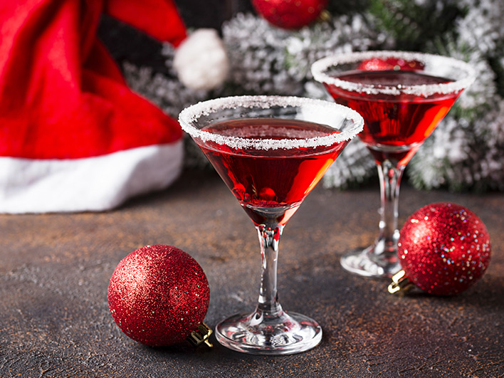 Gin glasses with sugar around the edges with christmas decorations in background