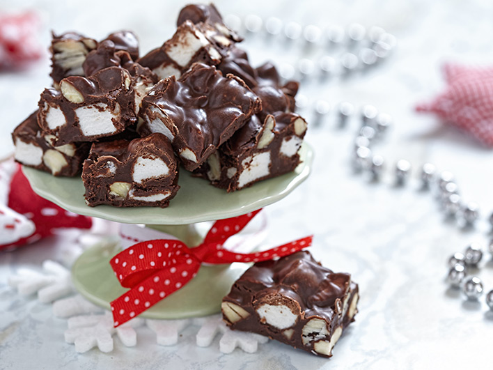 Chunks of rocky road on a stand with a red ribbon